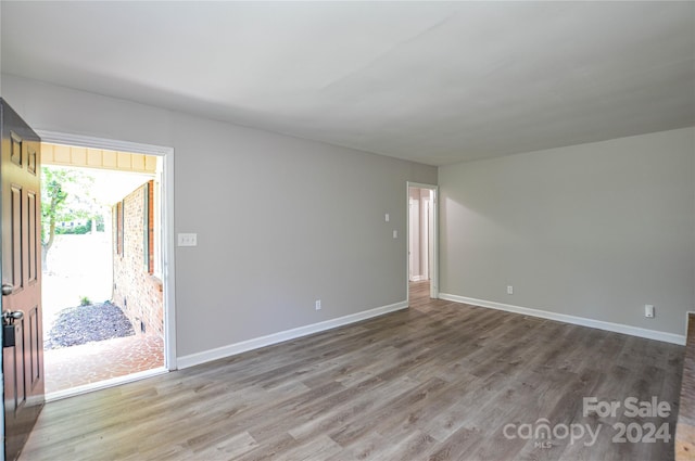 unfurnished room featuring hardwood / wood-style flooring