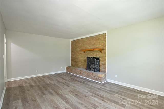 unfurnished living room with a fireplace and hardwood / wood-style flooring