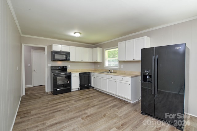 kitchen featuring sink, light hardwood / wood-style flooring, white cabinetry, and black appliances