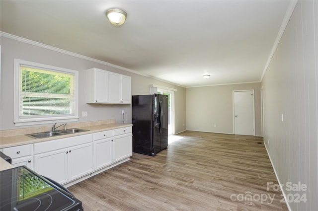 kitchen featuring white cabinets, black fridge with ice dispenser, sink, and light hardwood / wood-style flooring