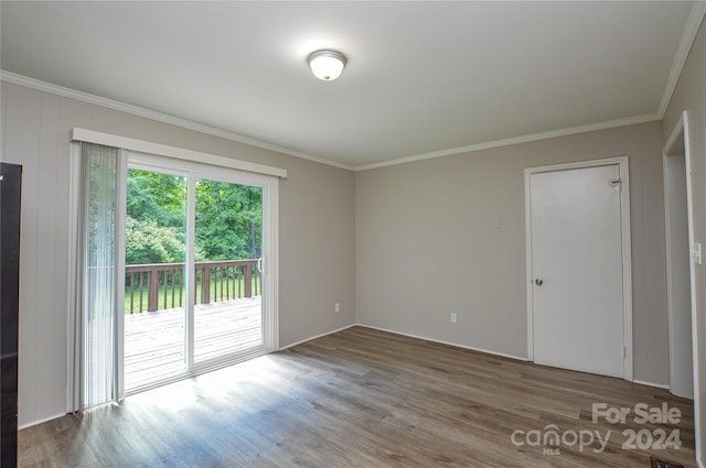 spare room with crown molding and hardwood / wood-style floors