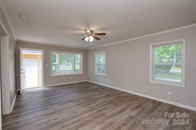 unfurnished room with hardwood / wood-style flooring, ceiling fan, and crown molding