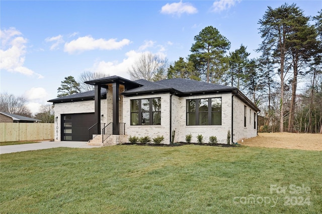 view of front of property with a garage and a front yard