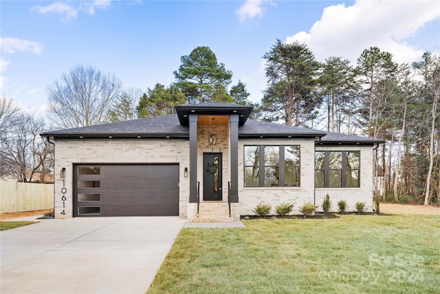 view of front of house featuring a front yard and a garage