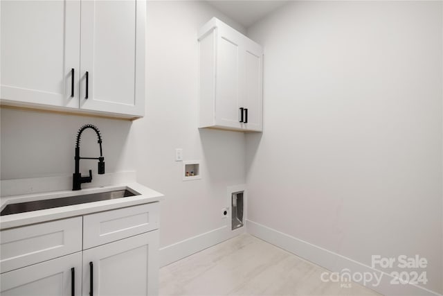 laundry room with electric dryer hookup, sink, cabinets, and washer hookup