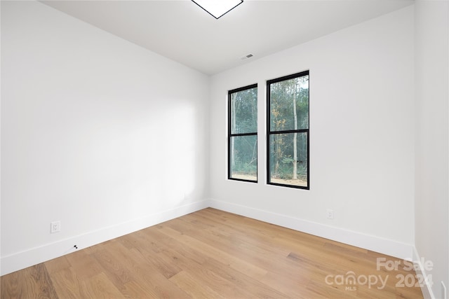 spare room featuring light wood-type flooring