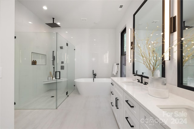 bathroom featuring vanity and shower with separate bathtub