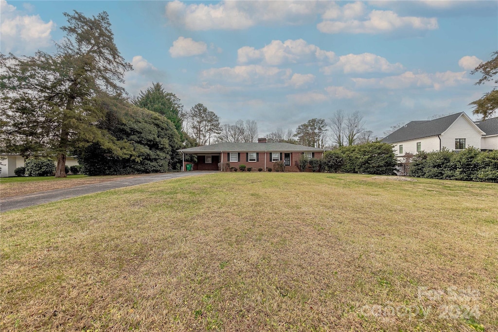 ranch-style home with a front lawn