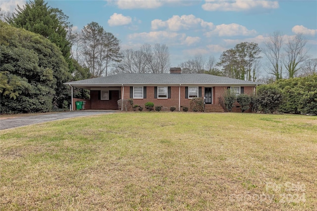 single story home with a carport and a front yard