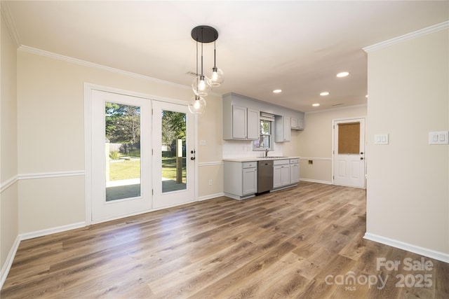 kitchen with hardwood / wood-style flooring, dishwasher, gray cabinetry, tasteful backsplash, and ornamental molding