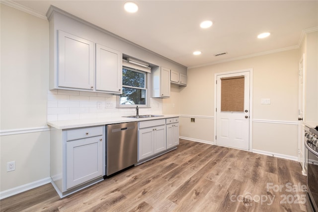 kitchen featuring dishwasher, sink, decorative backsplash, crown molding, and light hardwood / wood-style flooring