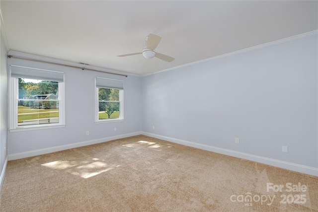 unfurnished room featuring crown molding, light colored carpet, and ceiling fan