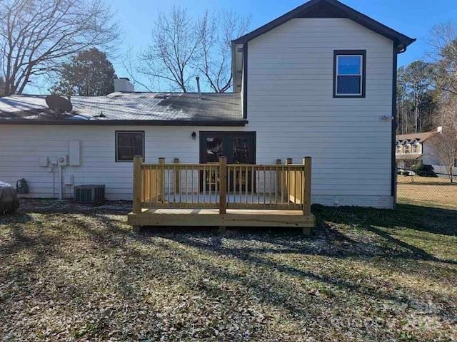 back of house featuring a wooden deck, central AC, and a lawn