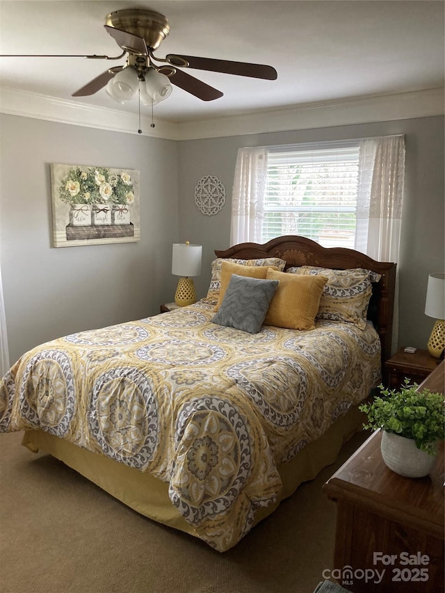 bedroom featuring ceiling fan, carpet floors, and crown molding