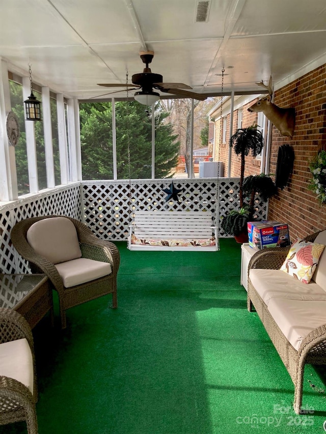 sunroom featuring ceiling fan