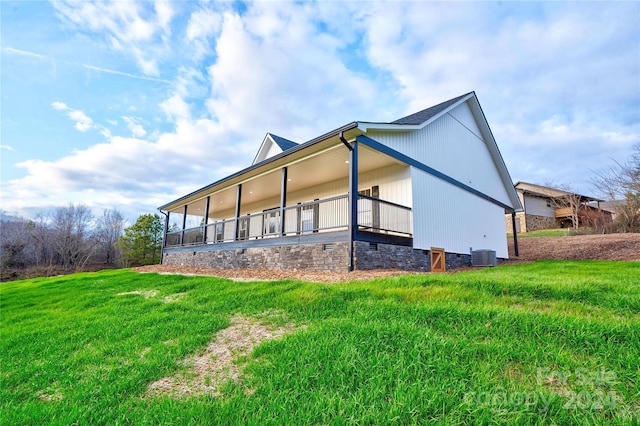 view of property exterior with central AC and a lawn