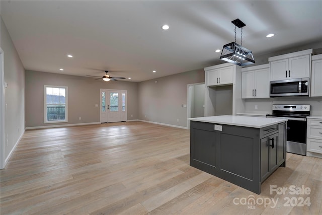 kitchen featuring white cabinetry, light hardwood / wood-style flooring, ceiling fan, and appliances with stainless steel finishes