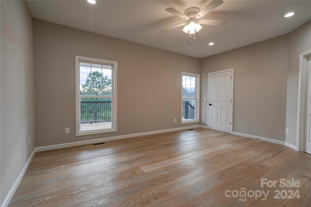 empty room featuring ceiling fan and light wood-type flooring