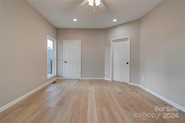 unfurnished room featuring light hardwood / wood-style flooring and ceiling fan