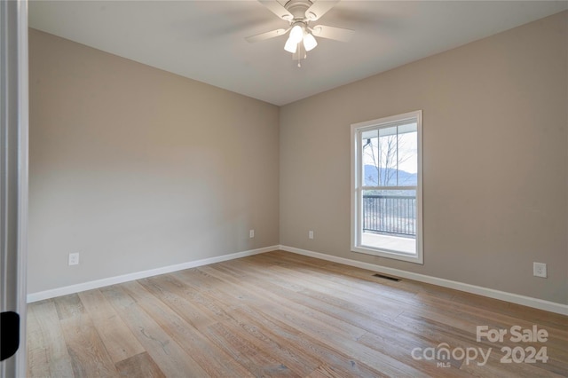 unfurnished room featuring ceiling fan and light hardwood / wood-style floors