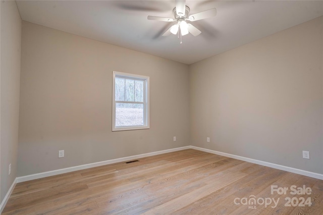 empty room featuring ceiling fan and light hardwood / wood-style flooring