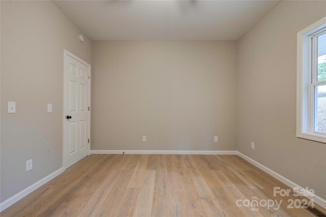 spare room with light hardwood / wood-style flooring