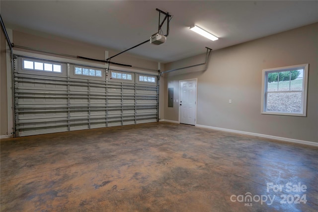 garage featuring electric panel and a garage door opener