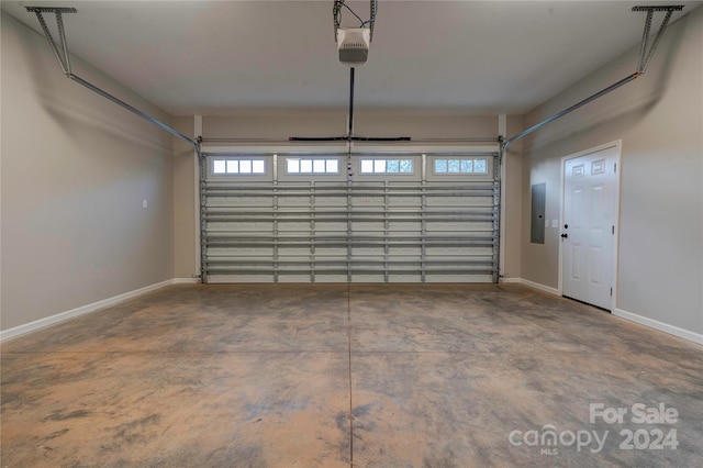 garage with electric panel and a garage door opener