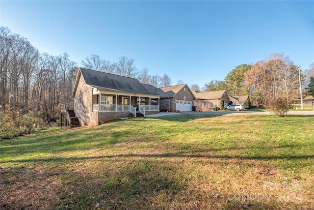 ranch-style house with covered porch, a garage, and a front yard