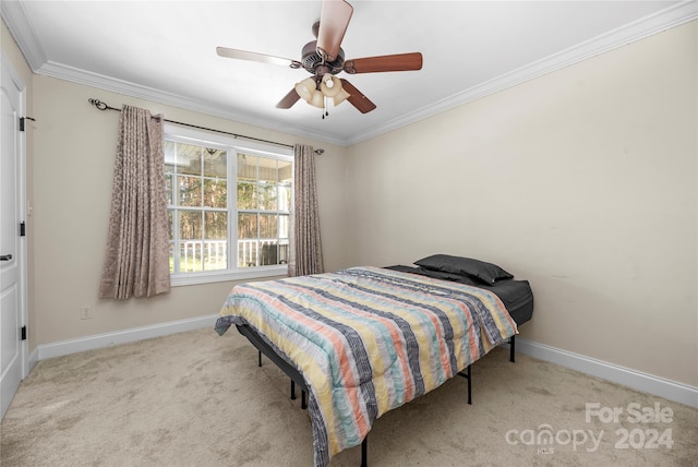 carpeted bedroom with ceiling fan and crown molding