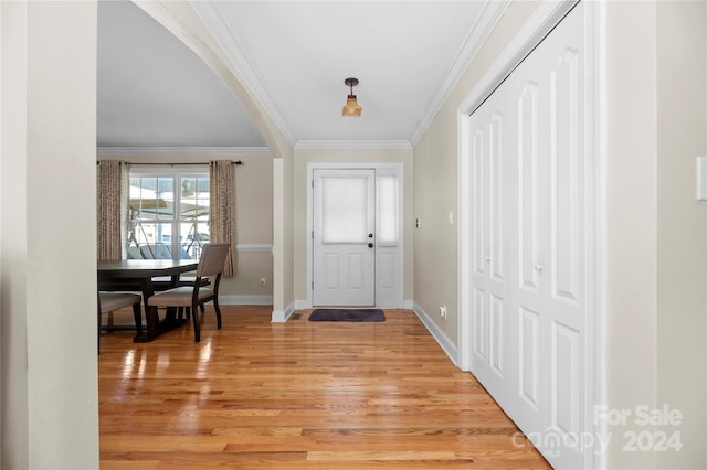 entrance foyer with light hardwood / wood-style floors and ornamental molding