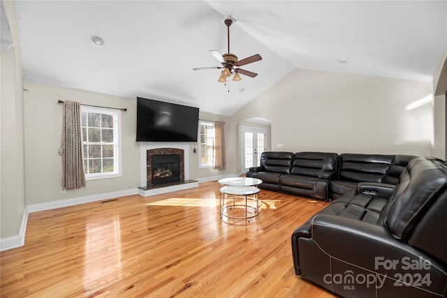 living room with hardwood / wood-style floors, plenty of natural light, ceiling fan, and lofted ceiling