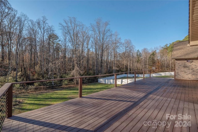 wooden terrace with a lawn