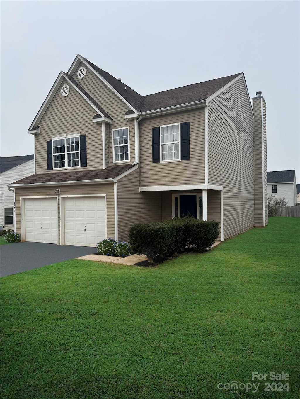 view of front facade with a front yard and a garage