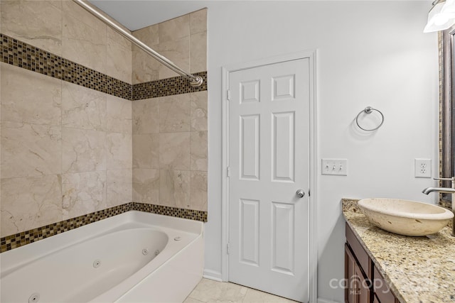 bathroom featuring tile patterned flooring, vanity, and tiled shower / bath combo