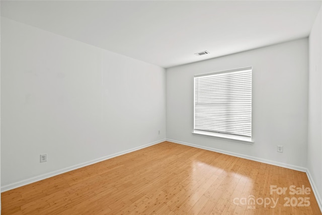 spare room featuring hardwood / wood-style flooring