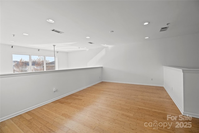 unfurnished room with light wood-type flooring