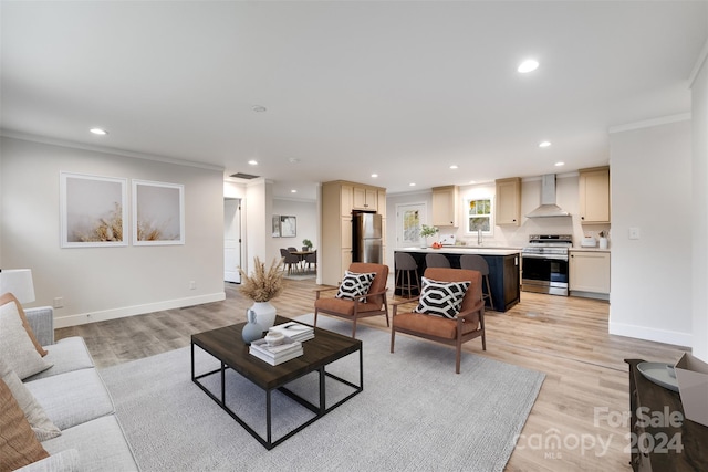 living room with ornamental molding and light wood-type flooring