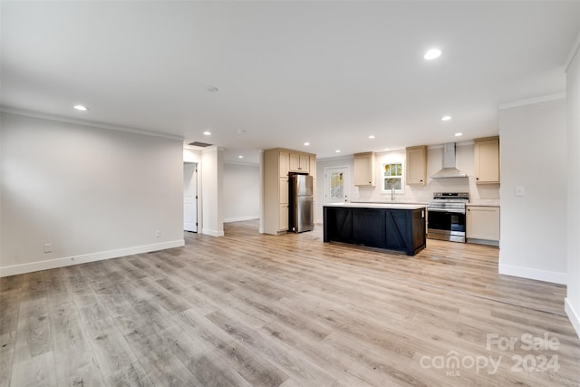 kitchen featuring appliances with stainless steel finishes, wall chimney exhaust hood, crown molding, a center island, and light hardwood / wood-style floors