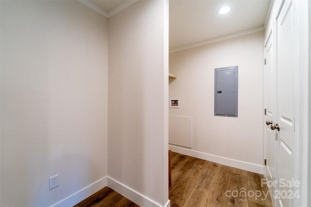 laundry area with electric panel, hardwood / wood-style floors, and ornamental molding