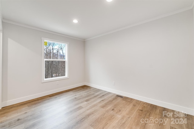 unfurnished room featuring crown molding and light wood-type flooring