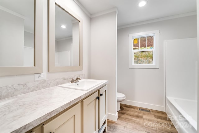 bathroom featuring vanity, hardwood / wood-style flooring, toilet, and crown molding