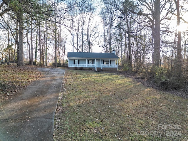 view of front of property with a porch and a front yard