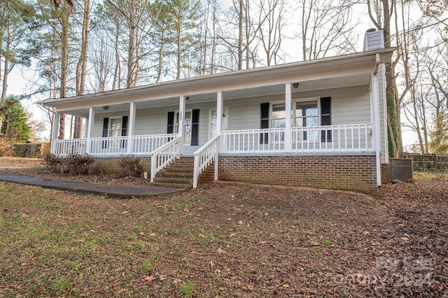 view of front of house with a porch and central air condition unit