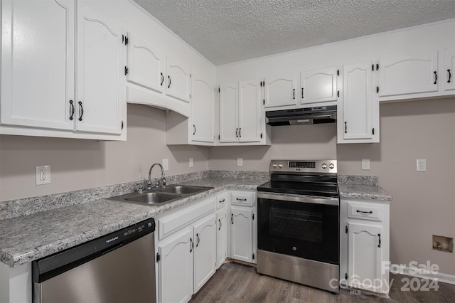 kitchen with dark hardwood / wood-style flooring, sink, white cabinets, and stainless steel appliances