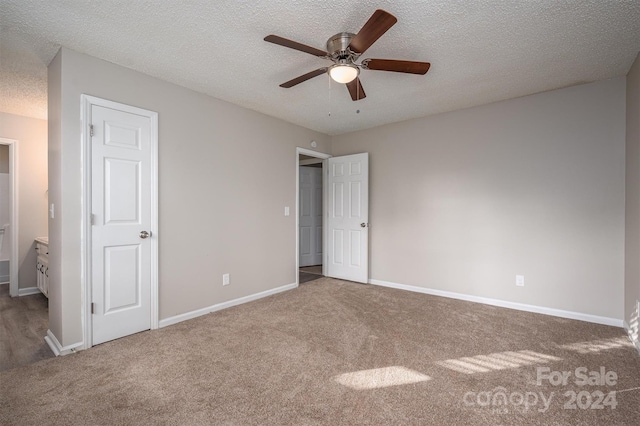 unfurnished bedroom with carpet, ceiling fan, and a textured ceiling