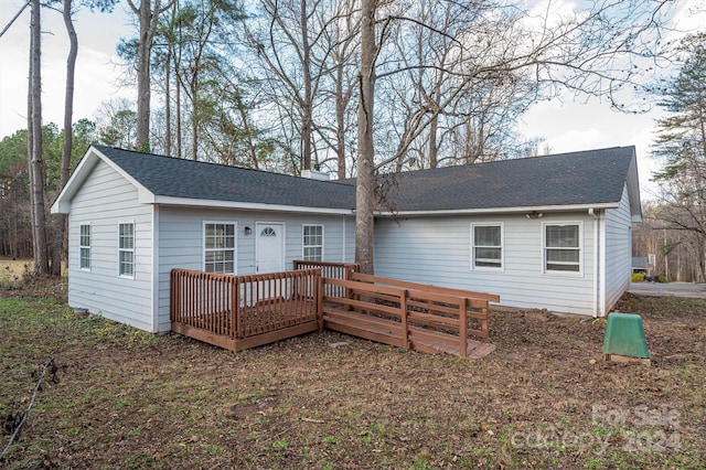 back of property with a wooden deck