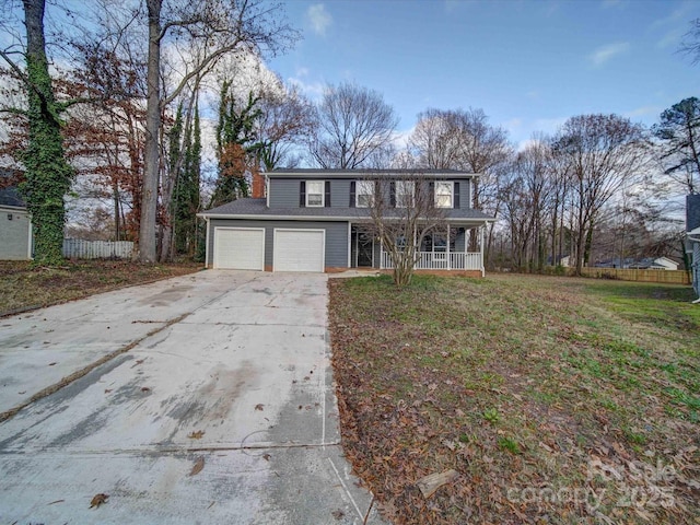 view of front property with a garage, a front yard, and covered porch