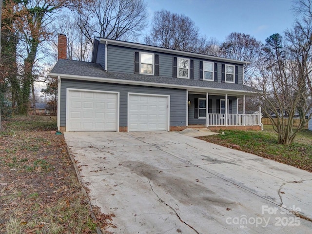 view of front property with covered porch and a garage