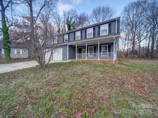 view of front of property with a front lawn, covered porch, and a garage